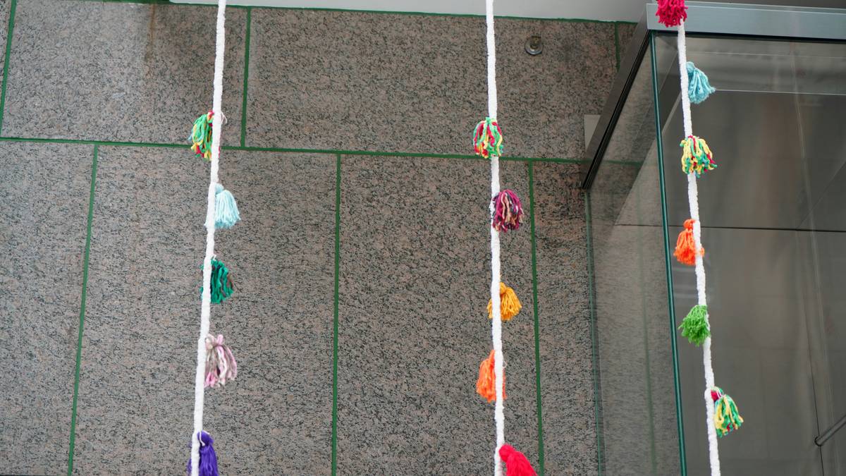 easy diy graduation decorations table setup with handmade pom poms and photo display