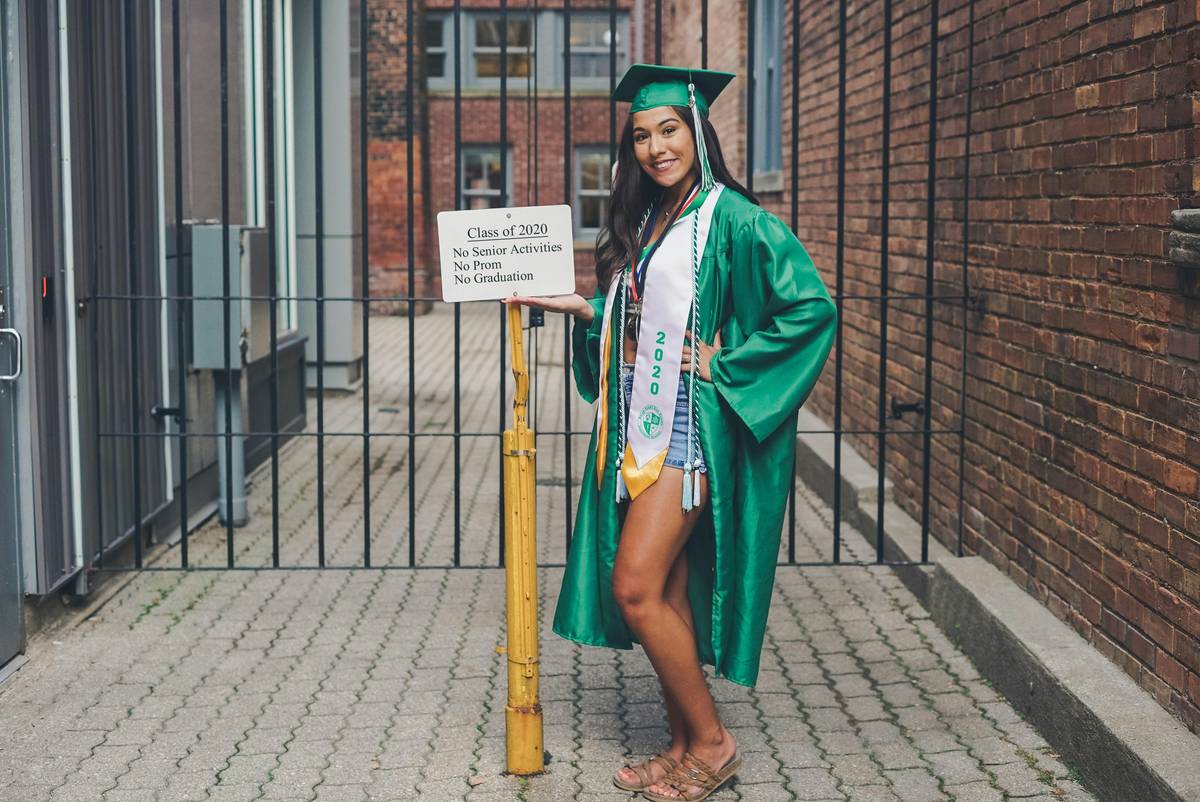 green and black graduation decorations featuring metallic balloons, custom banners, and table runners arranged on a patio setup