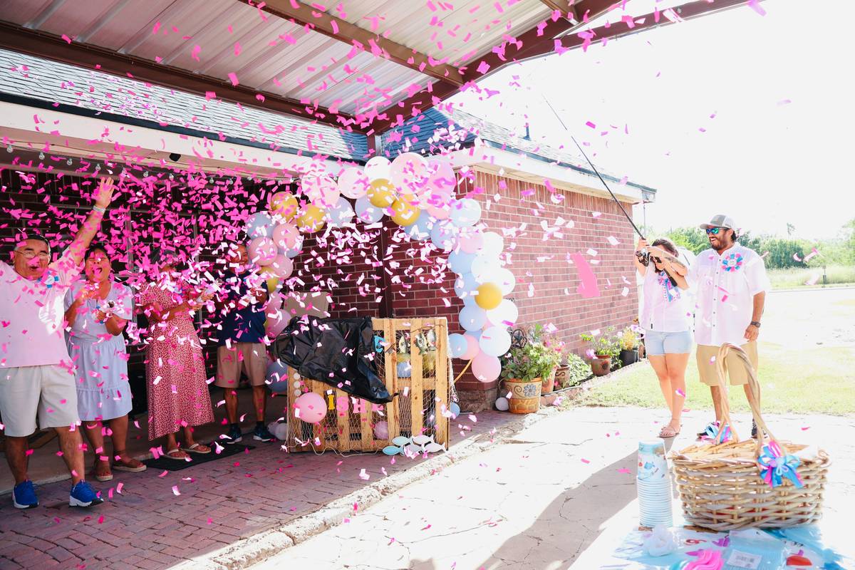 pink graduation decor ideas featuring rose gold balloons, photo garland, and minimalist table setting